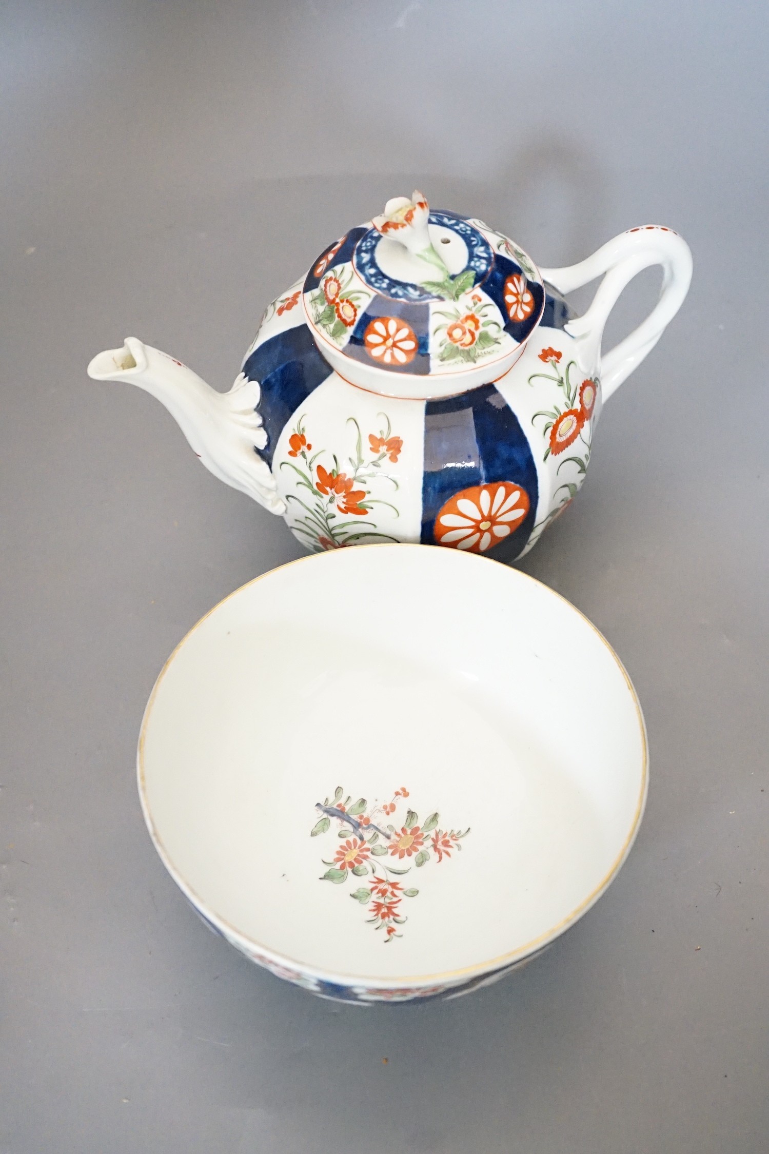 A Worcester teapot and cover, painted in the manner of the red line border group with the Queens pattern and a Worcester blue scale bowl painted with kakiemon flowers, teapot and cover 16cms high